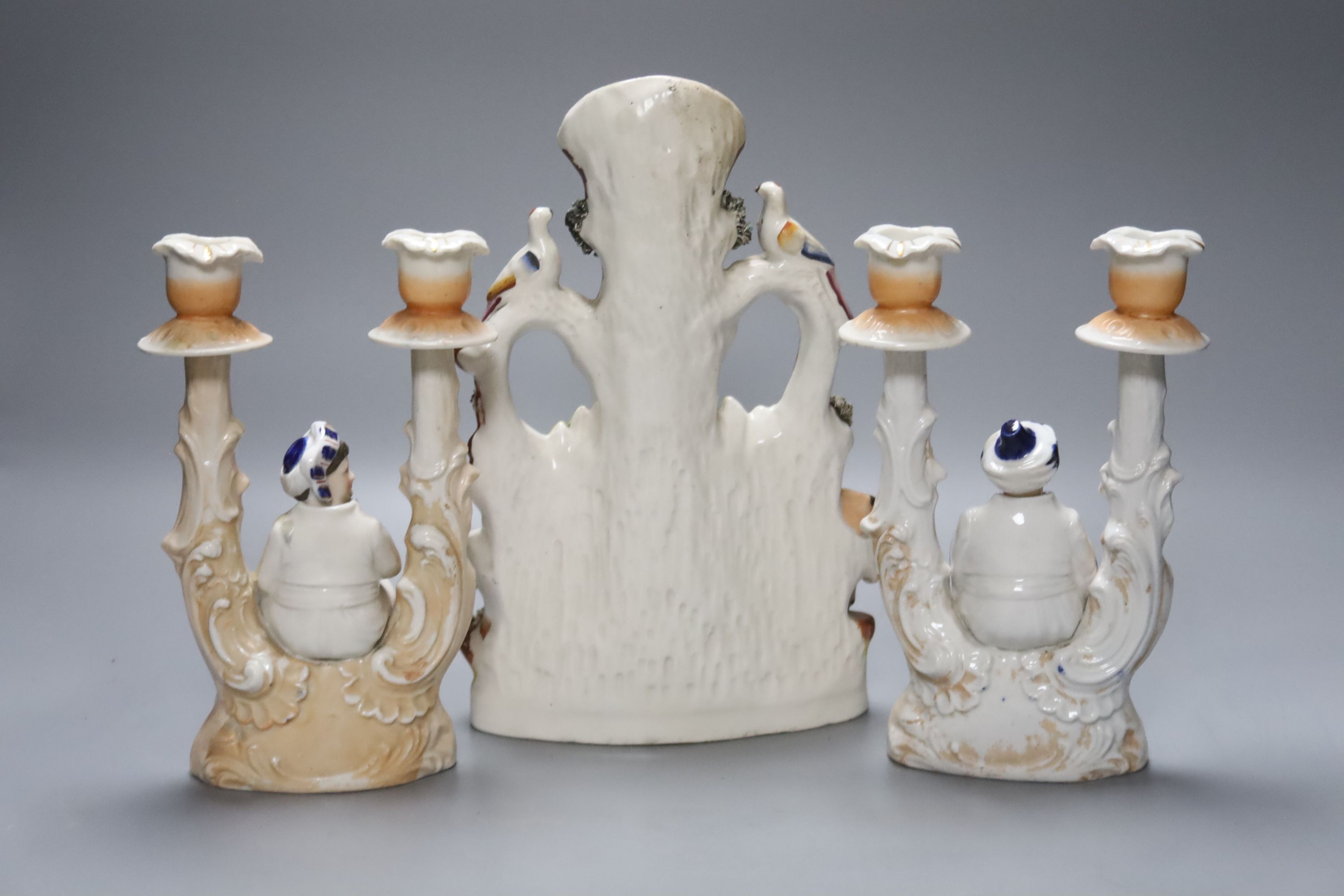 A Staffordshire flatback group of a horse and cow and a pair of novelty 19th century Continental porcelain nodding figural candlesticks